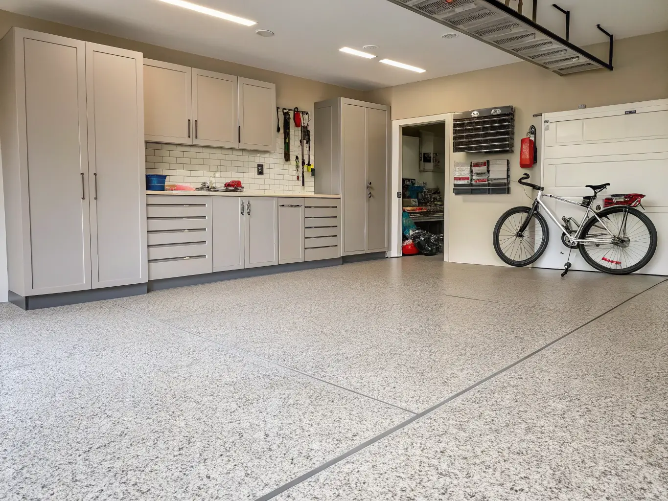 A high-resolution image of a beautifully coated residential garage floor with a glossy finish, showcasing the quality and aesthetic appeal of J3-Coatings' residential services.